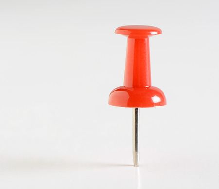 One red plastic marker on white backgroundの写真素材