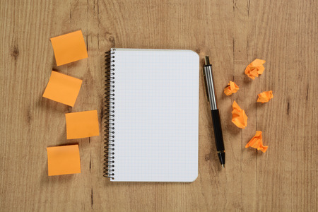 Paper notes and notebook on brown backgroundの写真素材