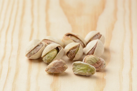 Roasted pistachio nuts on wooden backgroundの写真素材