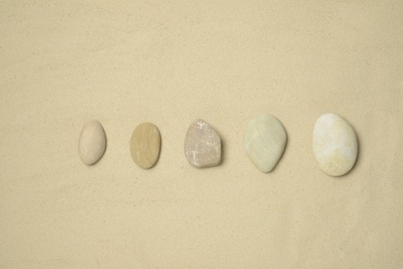 Some stones on the sand, brown sandの写真素材