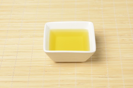 Oil in a bowl on a wooden backgroundの写真素材