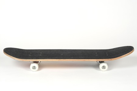 Black skateboard on white backgroundの写真素材