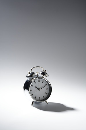 Classic alarm clock, of gray color with bellsの写真素材