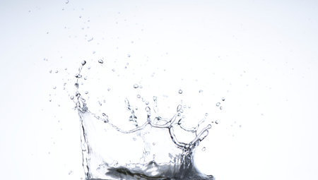Moving water on white background, jets and drops