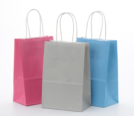 Pink, blue and gray paper bags on white backgroundの写真素材
