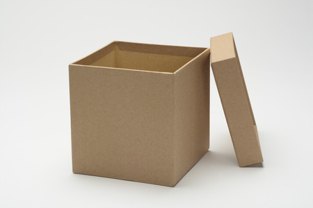 Box of gifts square like a cube of cardboard on white backgroundの写真素材