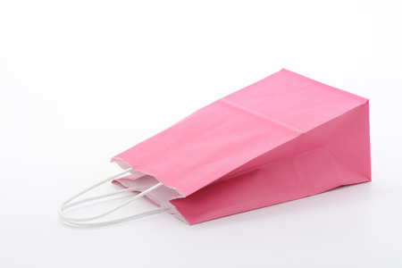 Bag for the purchase of pink paper on white backgroundの写真素材