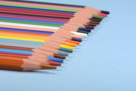 Colored pencils on blue backgroundの写真素材
