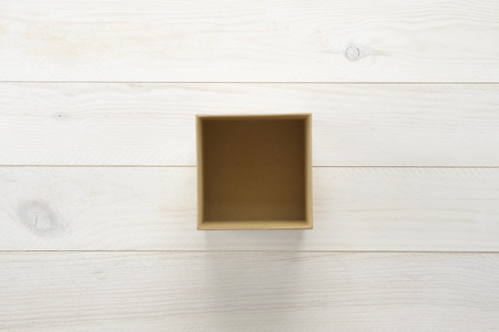Gift box on wooden white background, view from aboveの写真素材