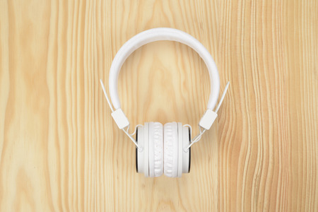 Headphones or helmets of white color on the wooden floorの写真素材