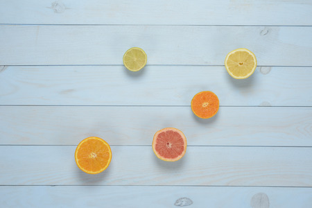 Citrus fruit on blue wooden background. Orange, tangerine, grapefruit, lemon and lime.の写真素材