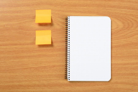 Paper notes and notebook on brown background