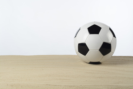 Soccer ball on the sandの写真素材