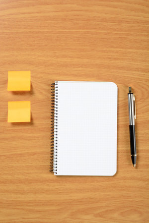 Paper notes and notebook on brown background