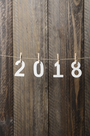 2018 written in wooden letters hanging from a rope, New Yearの写真素材
