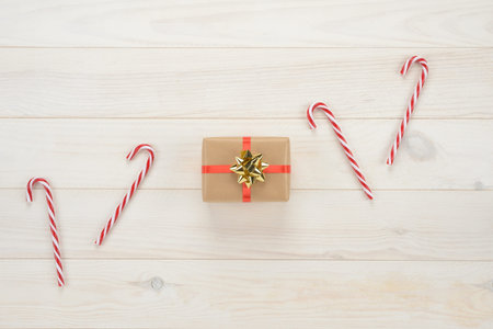 Gift box on wooden white background, view from above
