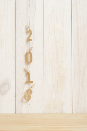 New year two thousand and eighteen in golden wood letters on wooden background, 2018の写真素材