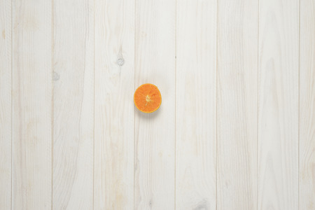 Tangerine on a wooden background cut in half, composition with frutisの写真素材