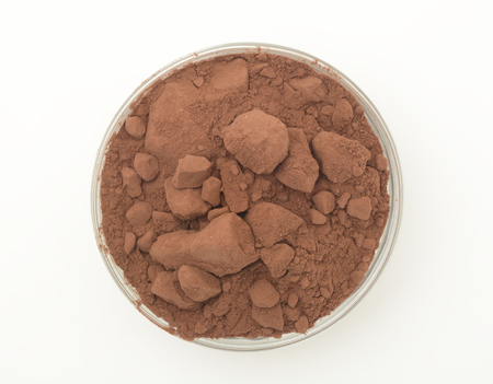 Cocoa powder in a glass bowl on white backgroundの写真素材