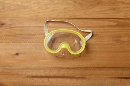 Dive glasses on wooden backgroundの写真素材