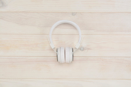 Headphones on white wooden background, view from aboveの写真素材