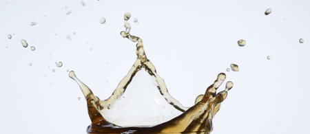 Splashes and drops of coffee on white backgroundの写真素材