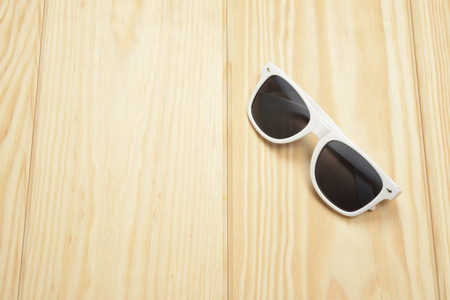 White sunglasses on the wooden floorの写真素材