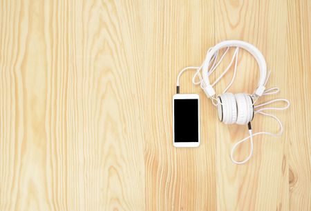 Headphones or helmets and telephone on wooden floor, multimedia productsの写真素材