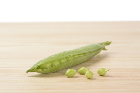 Raw peas on the wooden tableの写真素材