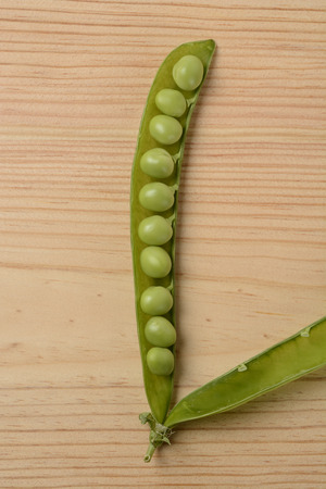 Raw peas on the wooden tableの写真素材