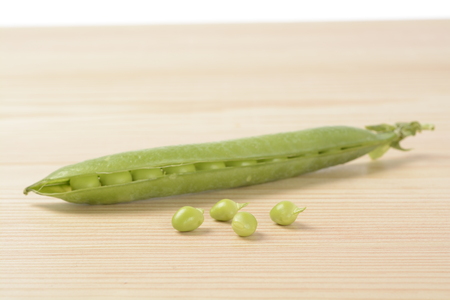 Raw peas on the wooden tableの写真素材
