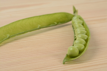 Raw peas on the wooden tableの写真素材