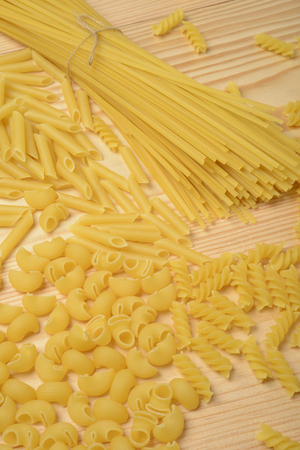 Varieties of raw pasta. Noodles, spirals, macaroni and elbow pasta.の写真素材