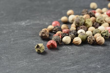 Pepper five varieties on black stone, macroの写真素材