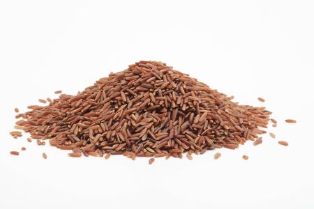 Raw wholegrain red rice on white backgroundの写真素材