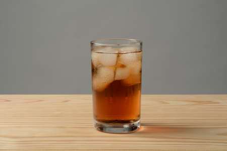 Glass of ice tea on the wooden tableの写真素材