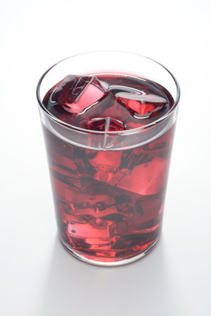 Glass of wine with ice cubes on white background, isolatedの写真素材
