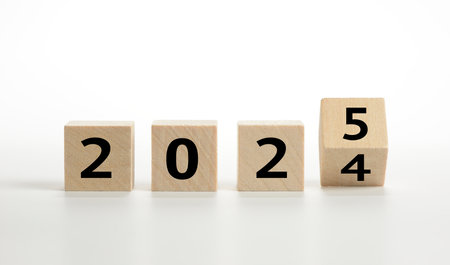 2025 in text on wooden cubes on white backgroundの写真素材