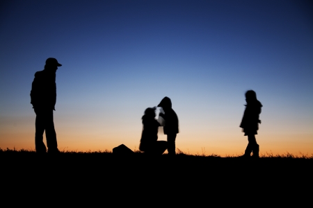 Family silhouette under the night skyの写真素材