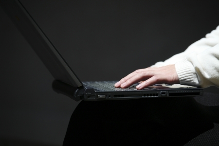 Laptop and handの写真素材