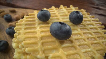Homemade waffles with berries in plate on grey wooden table.の写真素材
