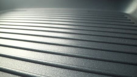 Surface of new metal grill pan. Abstract background.の写真素材