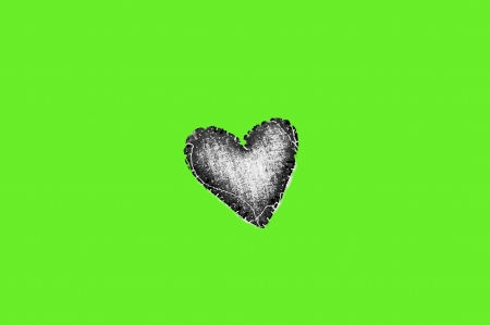Black heart with green backgroundの写真素材