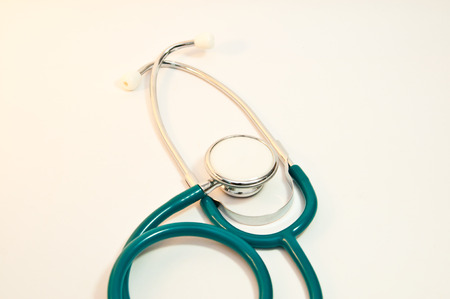 Stethoscope and hand with white backgroundの写真素材