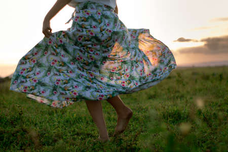 Closeup of the legs of the girl dancing outdoors in summertime. Beautiful Spring Young Woman Outdoors Enjoying Nature.の写真素材