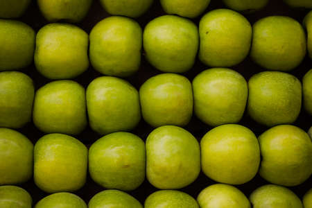 Ripe green apples close up view in Grocery Store Backgroundの写真素材