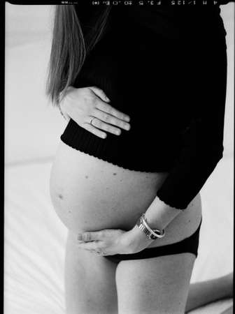 Pregnant lady in black top and pantの写真素材