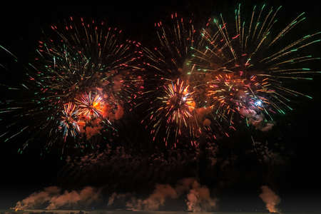 celebrating with Colorful Fireworks at dark night sky.の写真素材