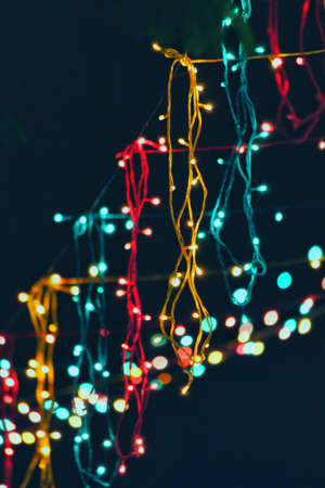 beautiful colorful Led string Light hanging on wire in dark night backgroundの写真素材