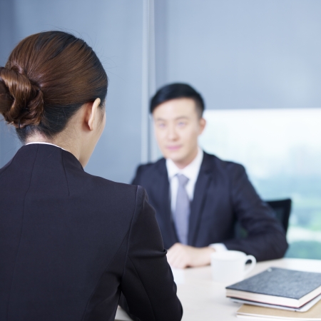 rear view of an interviewer talking to a nervous interviewee の写真素材
